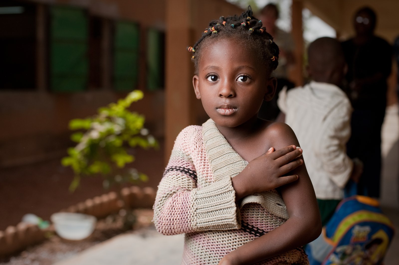 Female child, Oceane, holding a cotton ball to her arm after receiving a vaccine. Launch of MenAfriVac