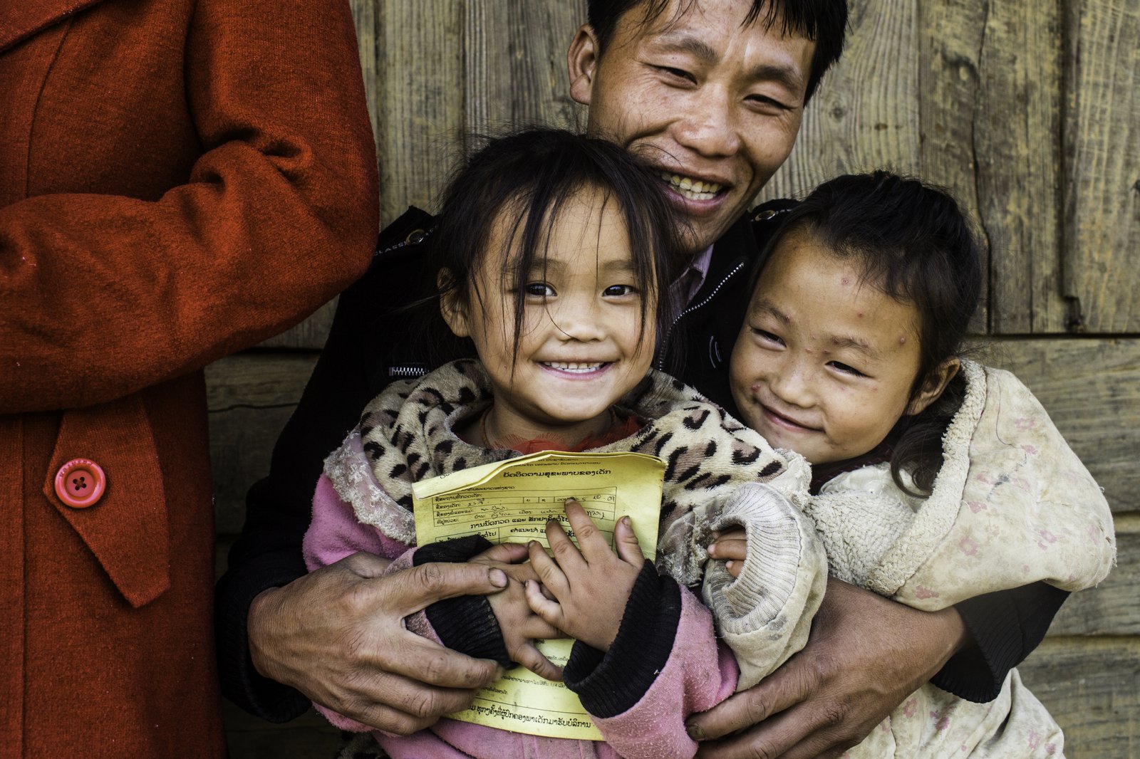 A family with their vaccination cards at the JE vaccination campaign in Khon Kahndone Village, Xieng Khouang province, Laos.