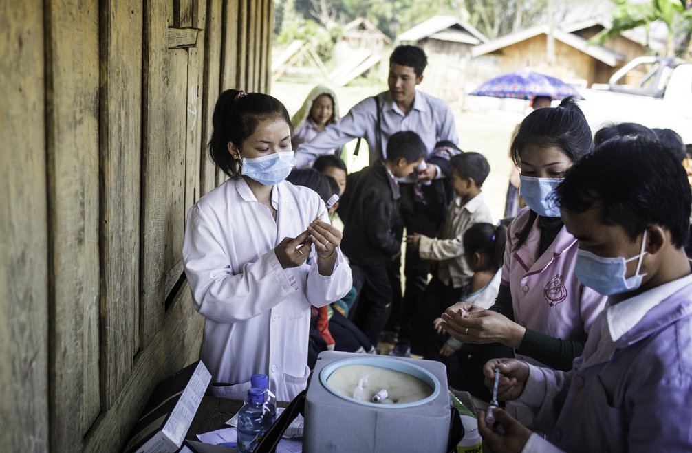 A group of health care workers prep vaccines for the JE campaign.