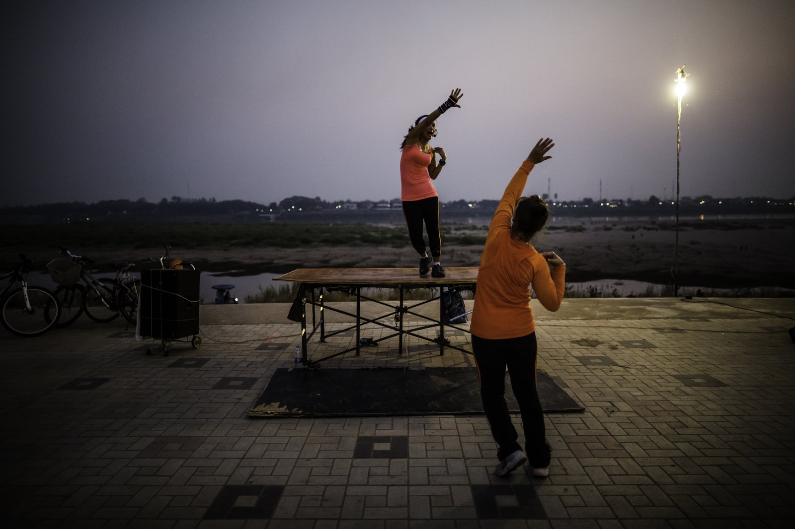 Groups of women exercise on the banks of the Mekong River in Vientiane, Laos. PATH/Aaron Joel Santos