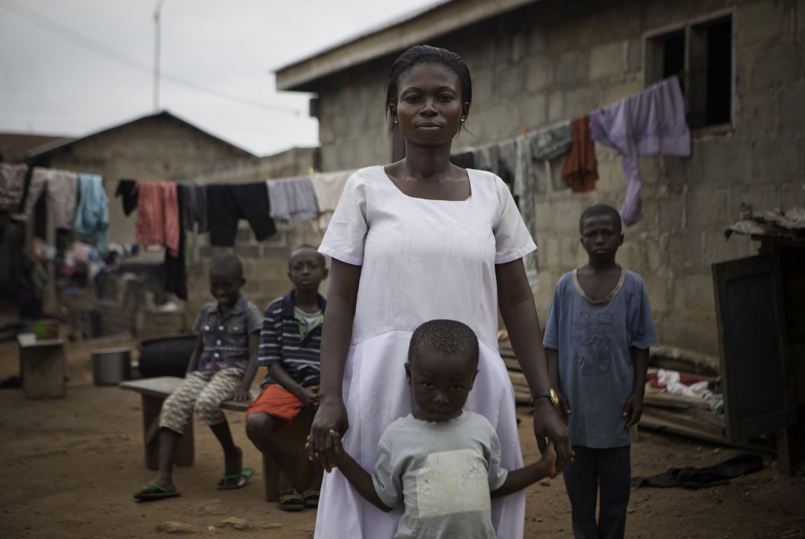 Vivian Badu (pictured) lost her sister Helena to severe bleeding during childbirth, and has since raised sister's children. They are representative of millions living with the aftermath of death in childbirth. Ghana. Photo: PATH/Evelyn Hockstein.