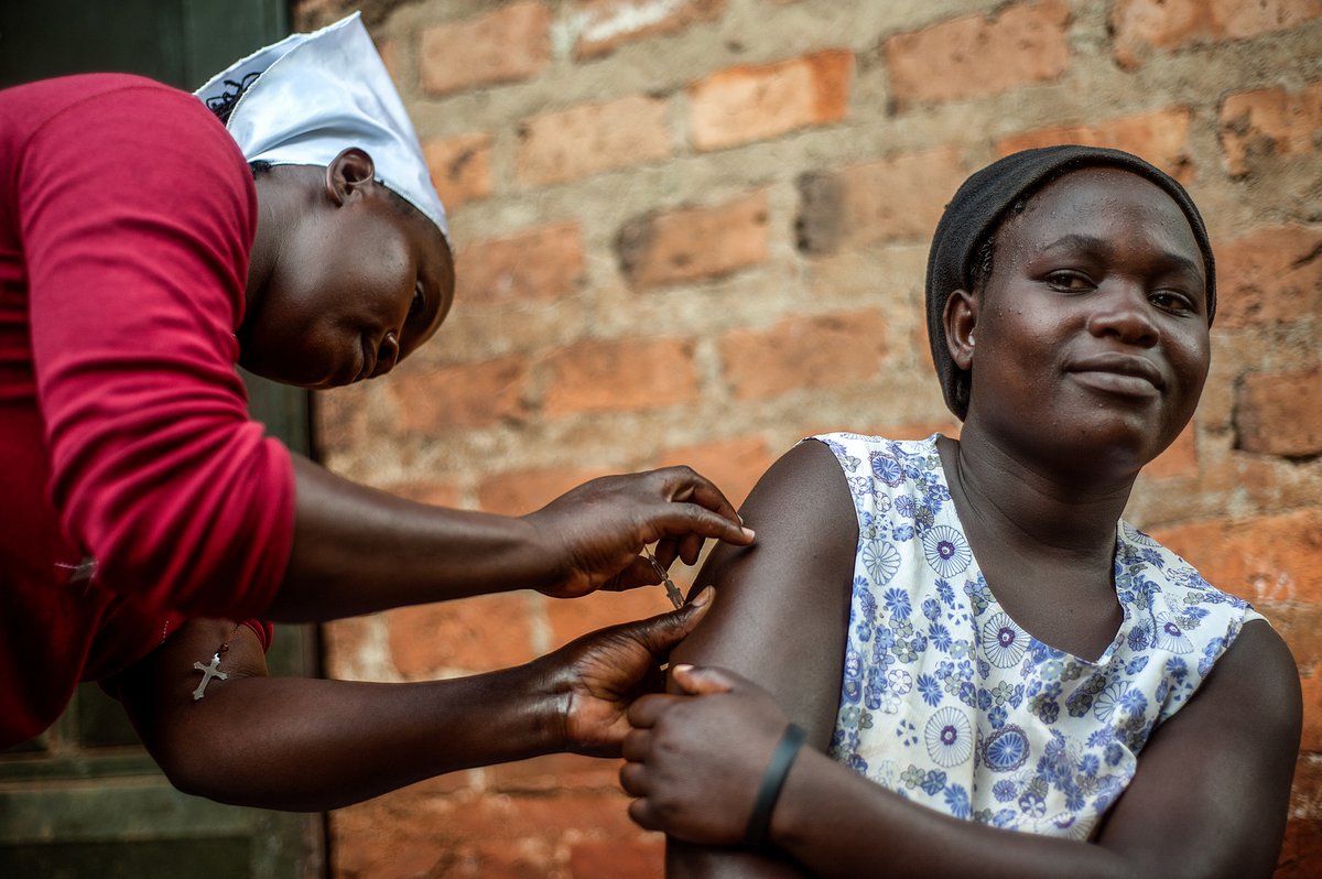 Phiona Nakabuye (left), a village health worker trained by PATH's Sayana® Press pilot program, with Carol Nabisere (right), age 18, who chose to receive Sayana® Press after being counseled in the various forms of contraception. Uganda. PATH/Will Boase.