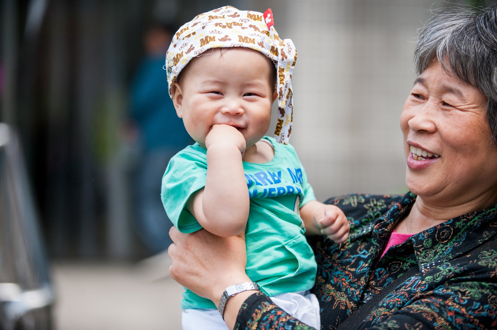 A woman holds a very young child in her arms. 