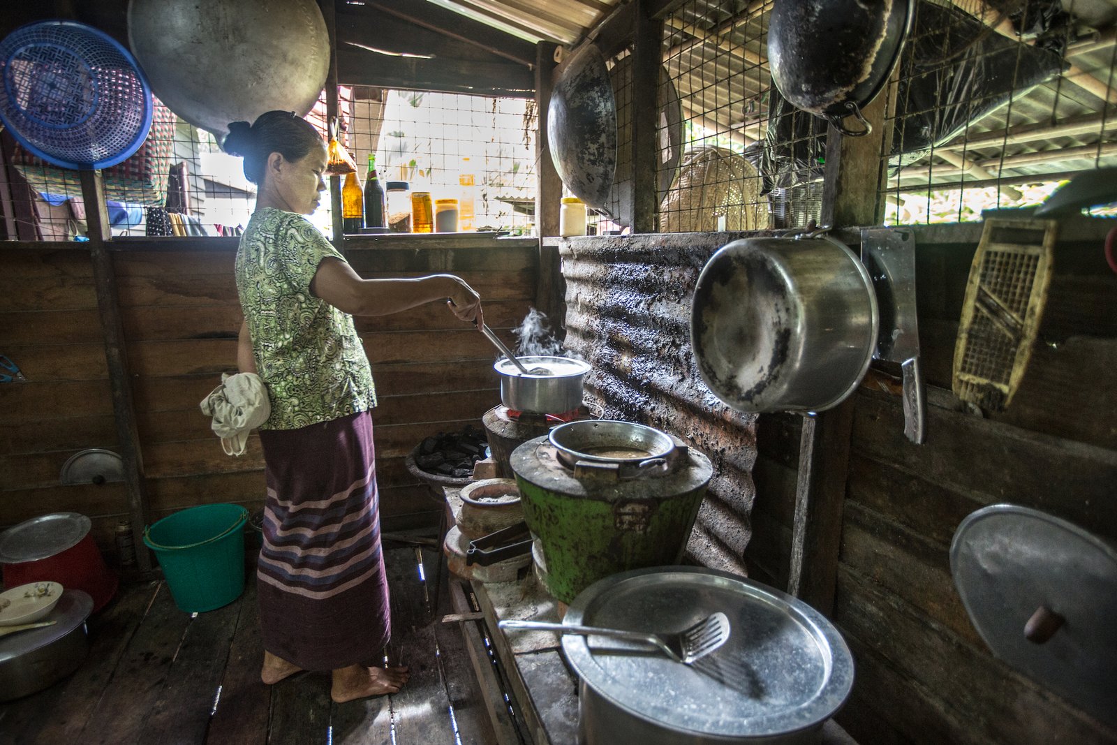 Daw Mya MyaAye, 58 years old, cooks fortified rice in Dala Township, Yangon, Myanmar. Photo: PATH/Minzayar.