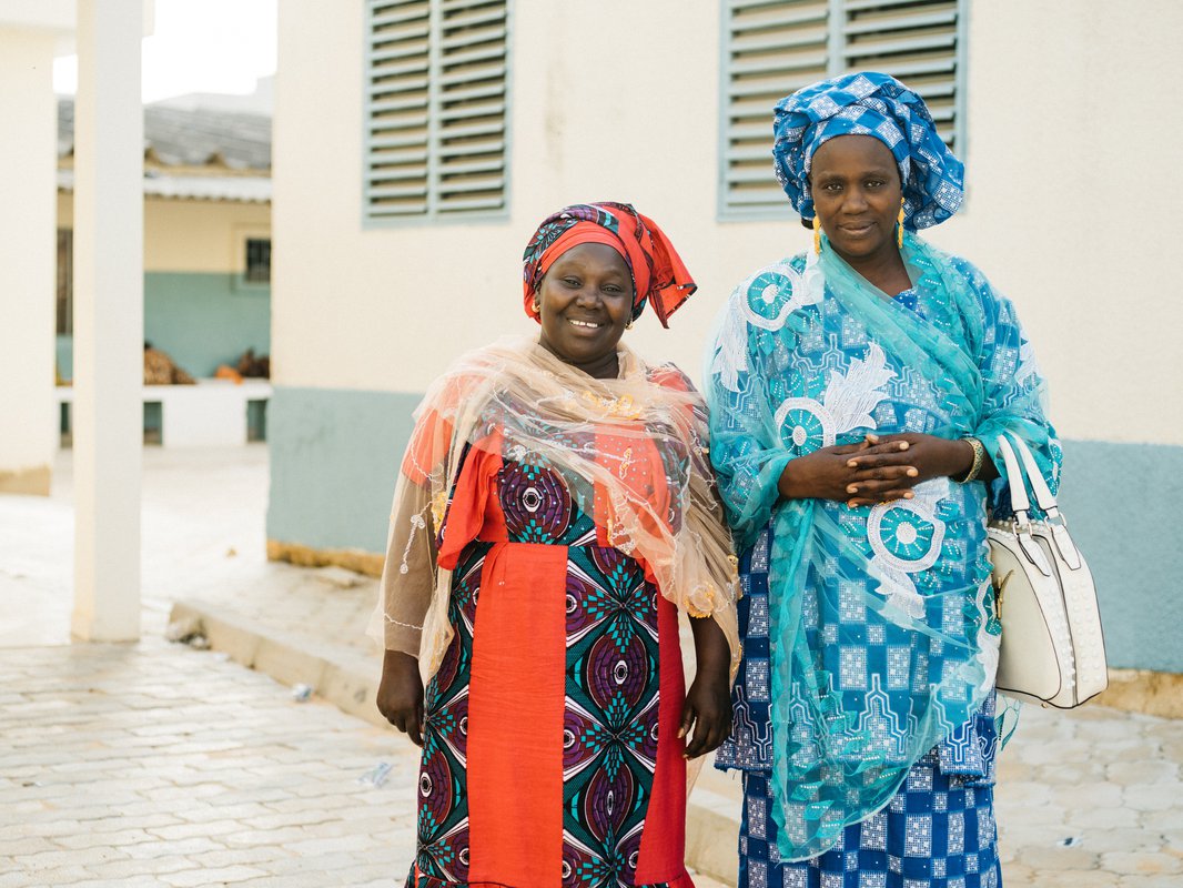 Aida (left) and Mame Fama Male (right in blue) are community health educators in Pikine, Senegal, who educate women about their family planning options. PATH/Gabe Bienczycki