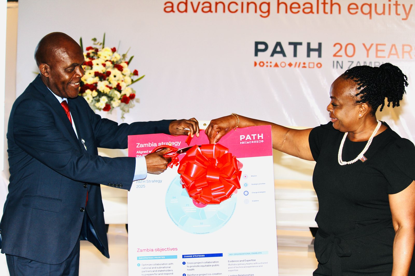 Dr. George Sinyangwe, Zambia's Permanent Secretary for Donor Coordination at the Ministry of Health, and Dr. Nanthalile Mugala, PATH's Chief of the Africa Region, unveil PATH Zambia’s strategic plan. Photo: PATH/Mundia Masuzyo.