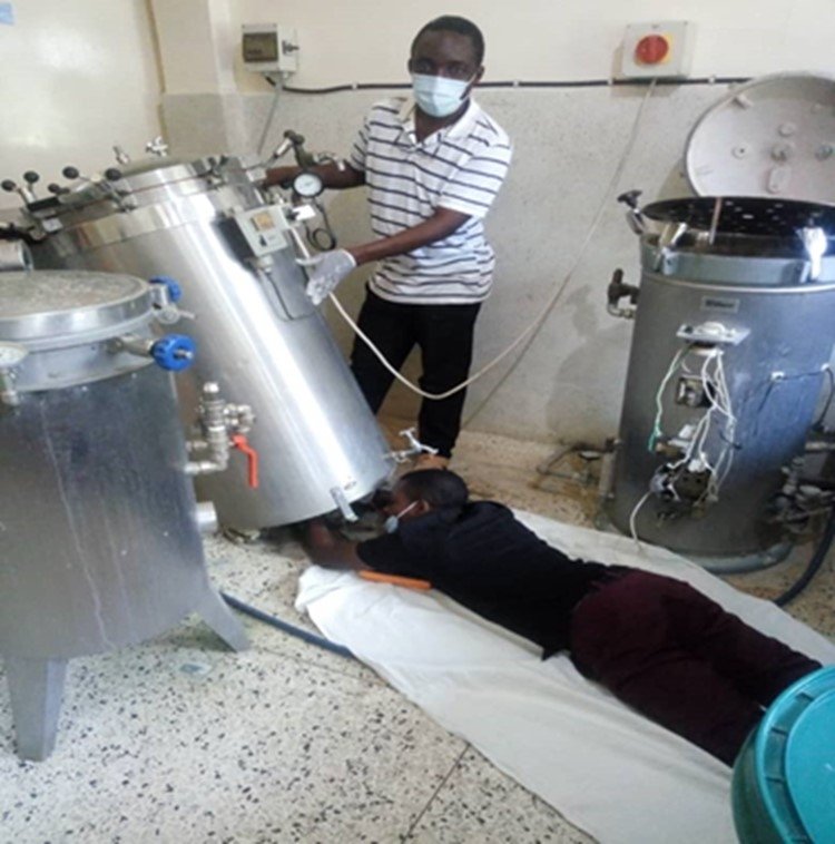 Biomedical engineers Haule Selwin and Aron Mahofu diligently rectify and restore malfunctioning medical equipment at Bunda District Designated Hospital in the Mara Region, Northern Tanzania.   Photo: PATH/Jackson Mugyabuso.