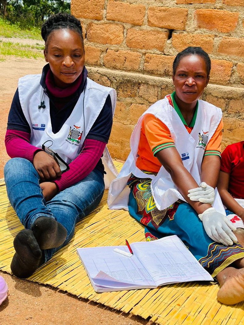 Data Community Health Worker Annie Mwale with Zenayida Banda. Photo: PATH/Mukomela Banda