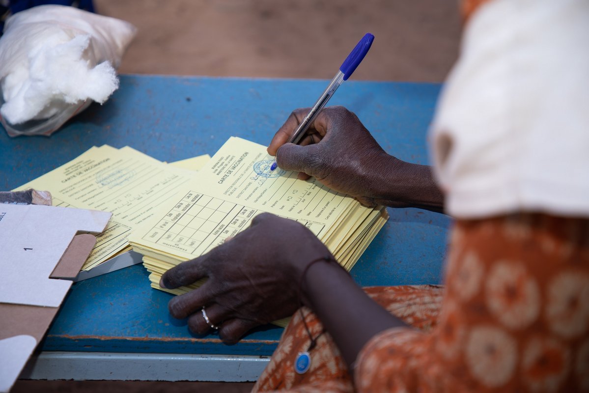 A health care worker prepares vaccination cards for Burkina Faso's TCV introduction campaign. Photo: PATH/Build Africa Communications.