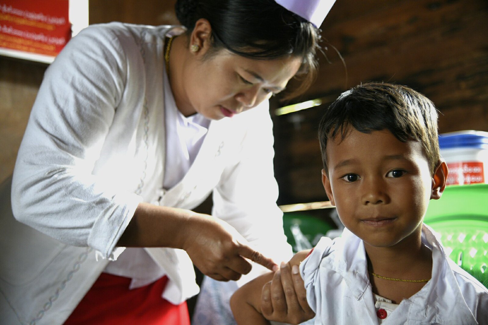 Boy being vaccinated in his upper arm.