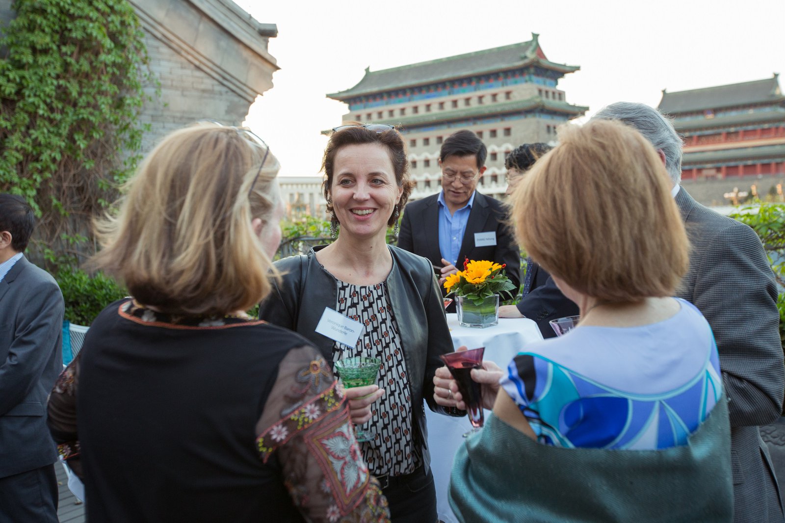 PATH Journeys travelers in China mingle on an outside patio at a PATH 40th anniversary celebration. 