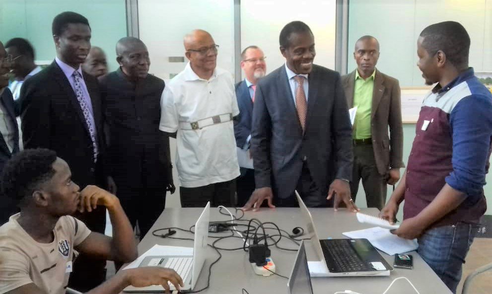 Hackathon-900.jpg . Participants in a hackathon in DR Congo chat with the minister of health. Photo: PATH