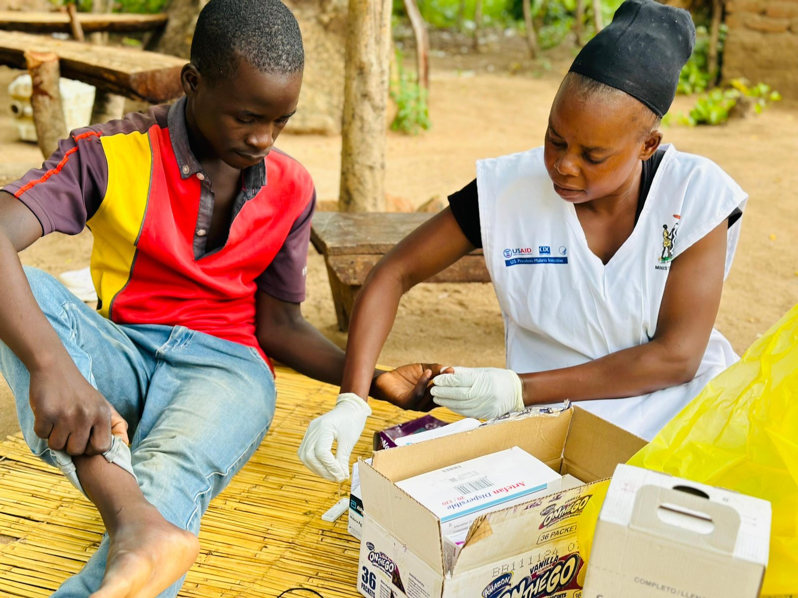 Margret Chalo, a Data Community Health Worker in Petauke, Zambia, tests a community member for malaria. Photo: PATH/Mukomela Banda