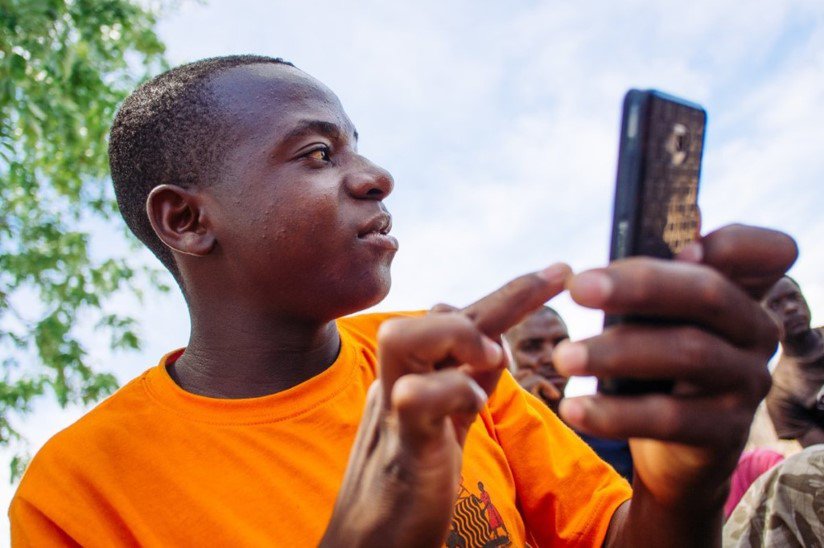 Data collector Odinga Chitonka, working in a remote part of Zambia, uses mobile technology to track malaria. Photo:PATH/Gabe Bienczycki