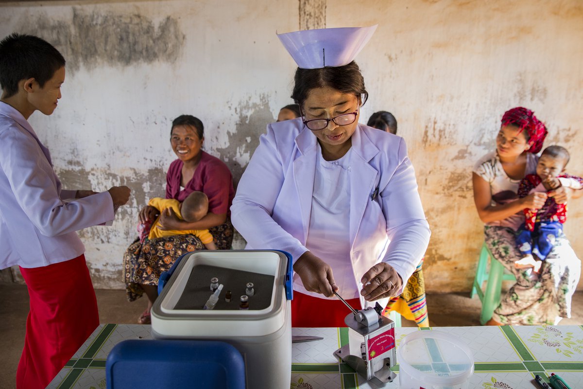 Midwife in Myanmar with needle cutter