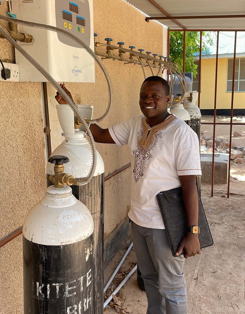 A biomedical engineer assesses an oxygen cylinder manifold at Dodoma Regional Referral Hospital in Tanzania. Photo: PATH/Conner House