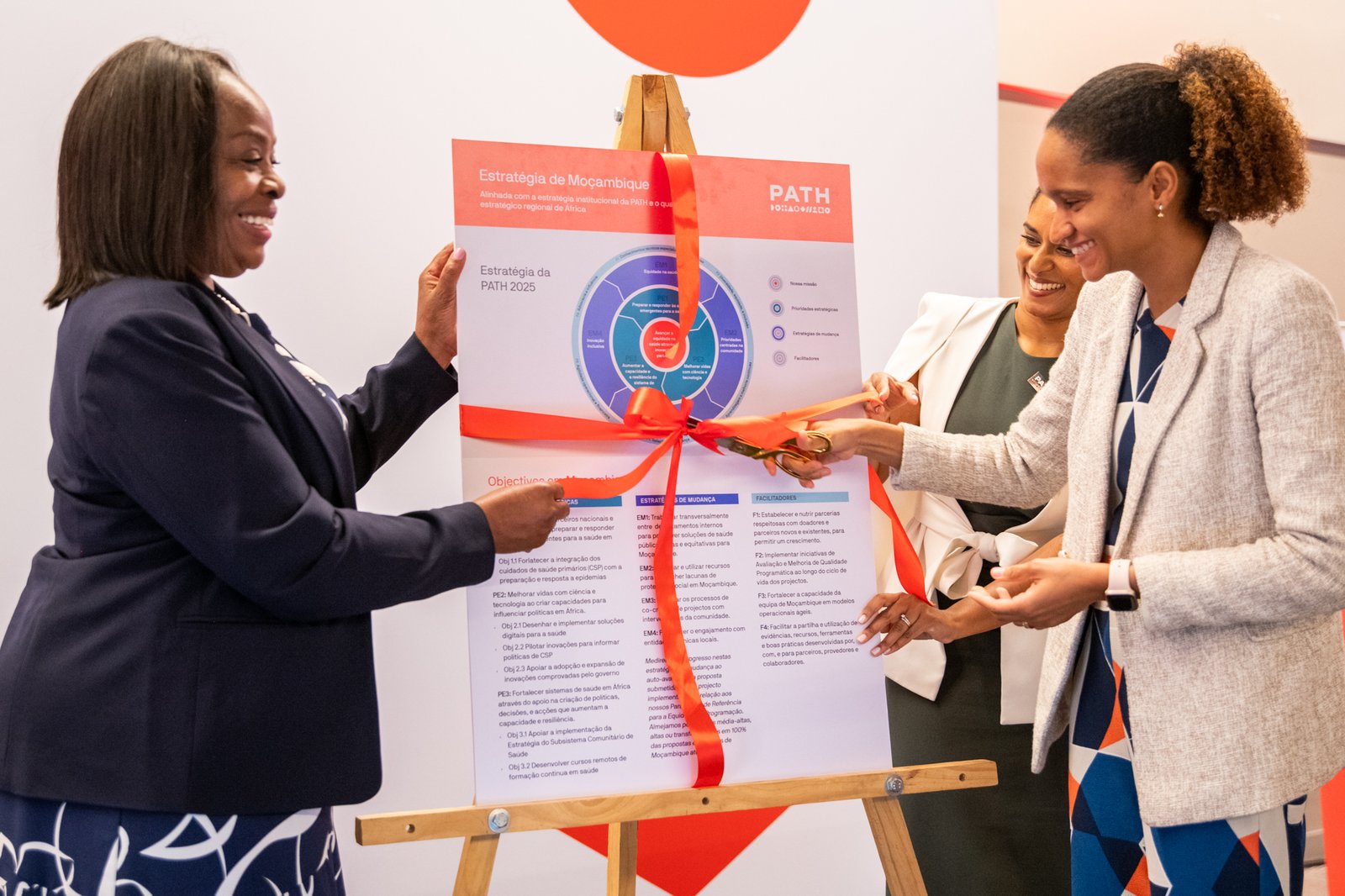 Dr. Annette Cassy, Deputy Director of Planning and Cooperation at the Mozambique Ministry of Health cuts a ribbon to launch the PATH Mozambique 2025 Strategy. Photo PATH/Paulo Alexandre.