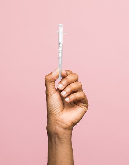 PATH image of syringe in hand on pink background syringe-hand-on-pink-2000-MB25944.jpg
