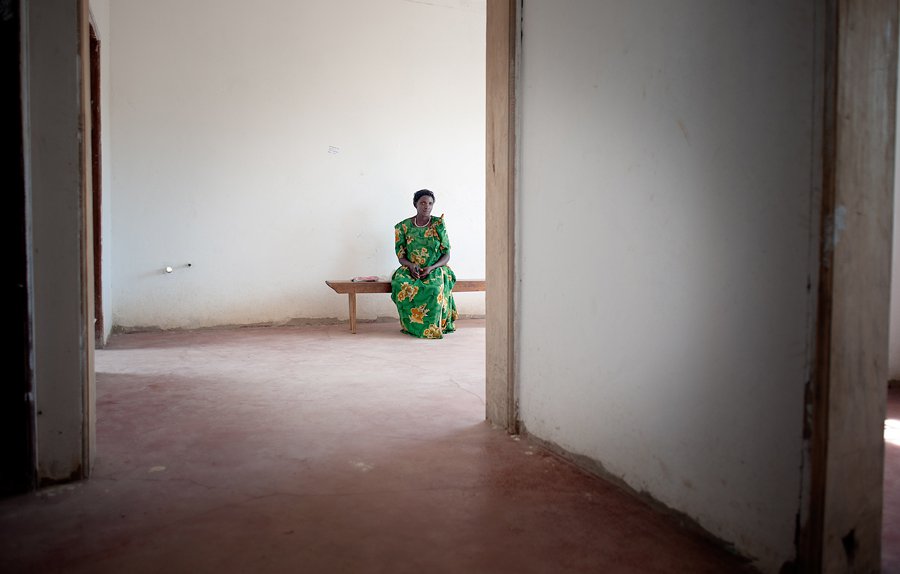Woman on bench in empty clinic space.