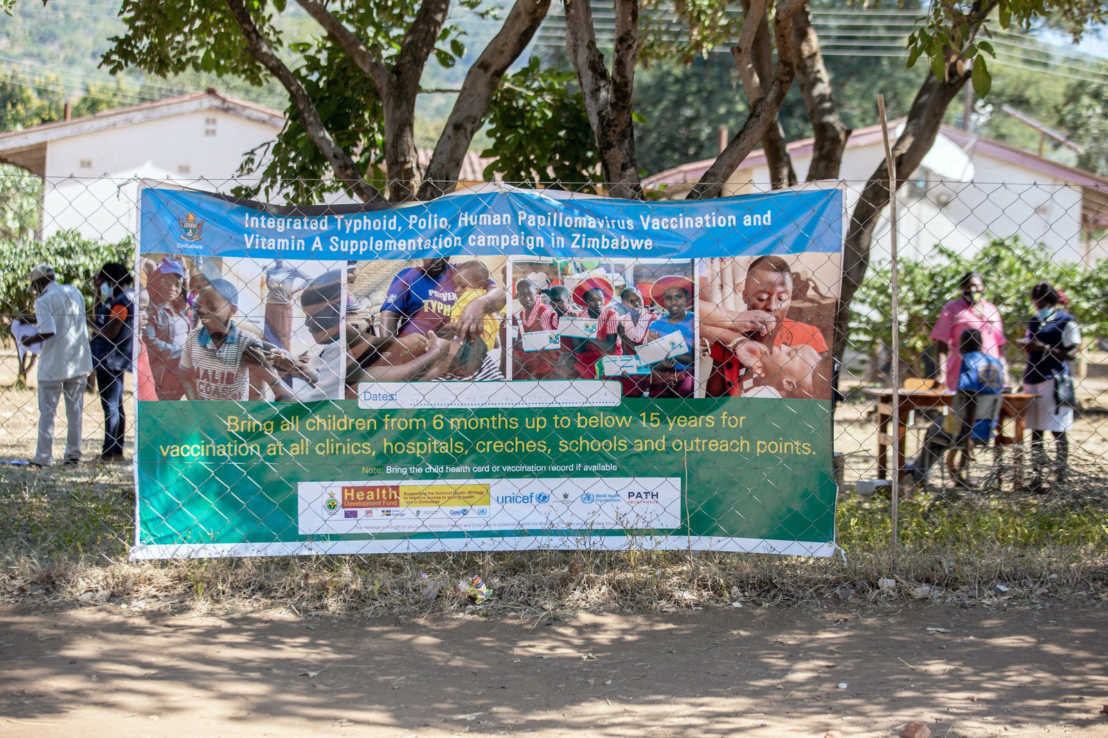 A poster hangs outside one of the vaccination sites for the typhoid conjugate vaccine campaign in Zimbabwe. PATH/Kudzai Tinago.
