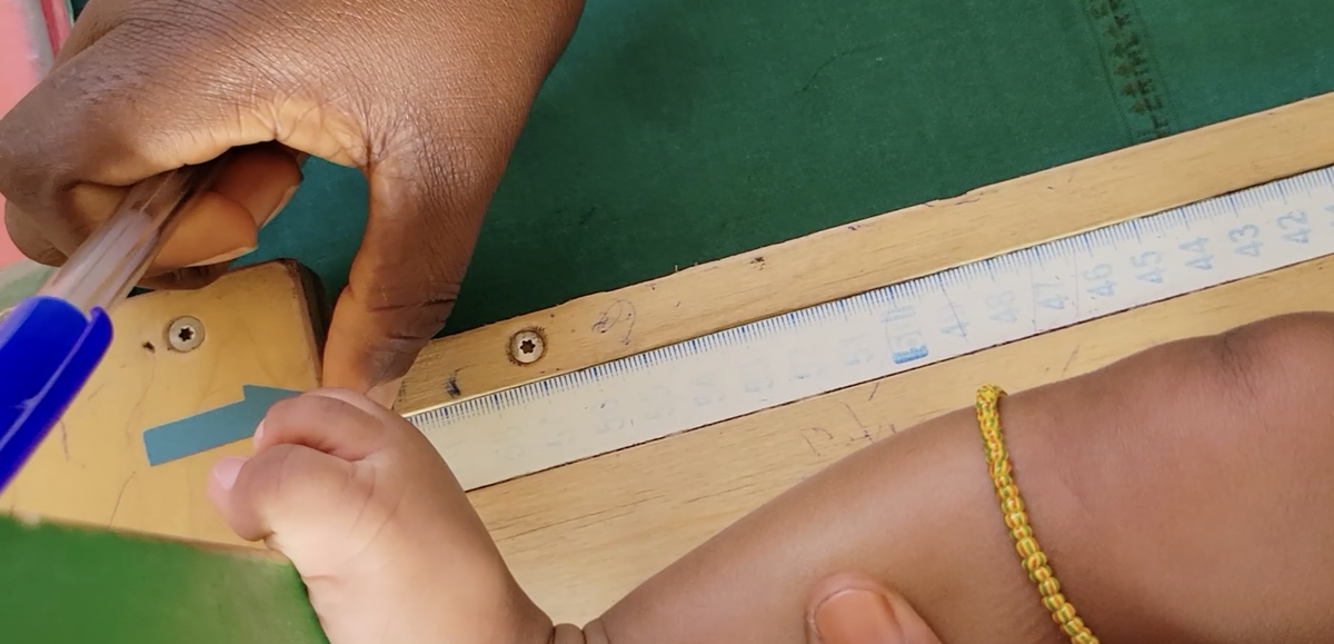 A newborn is measured during a routine checkup at a health clinic in Ghana. Photo: PATH.